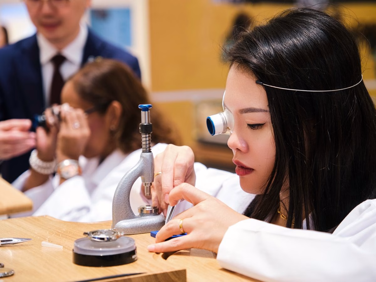 Participant using a loupe at the ZENITH watchmaking workshop