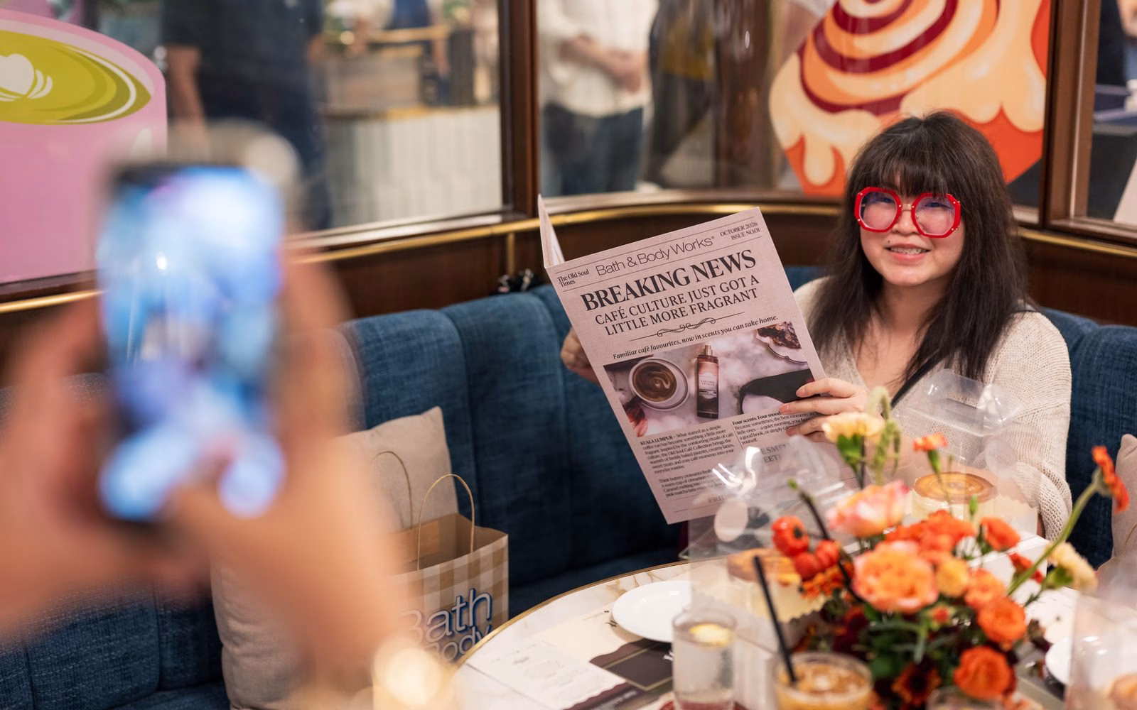A guest reading the Café Collection newspaper menu