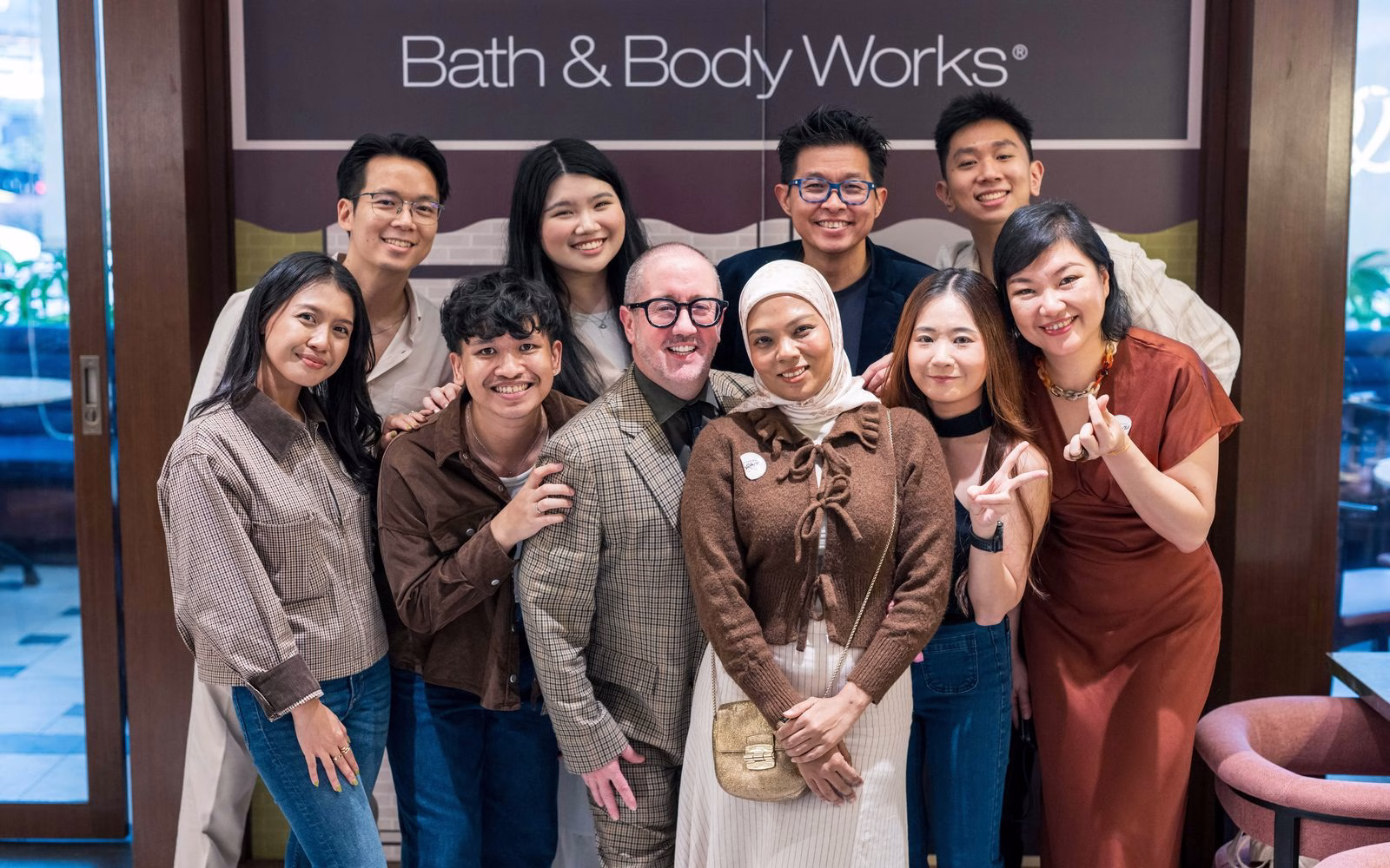 Guests at the Café Collection launch in front of the Bath & Body Works café set