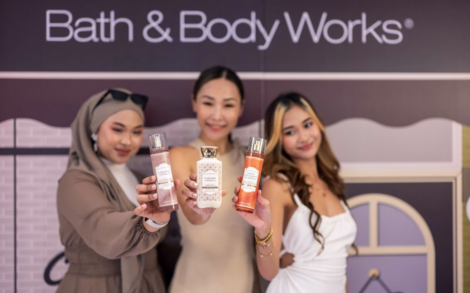 Guests holding Café Collection fine fragrance mists